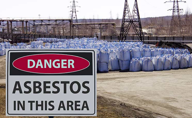 Danger area sign and big asbestos bags.