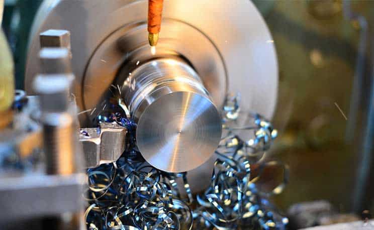 Professional machinist. Horizontal shot of a man operating lathe grinding machine metalworking industry