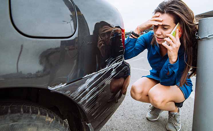 woman stand near scratched auto. call for help. car insurance