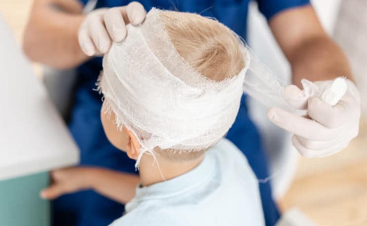 Doctor Wrapping Child Head